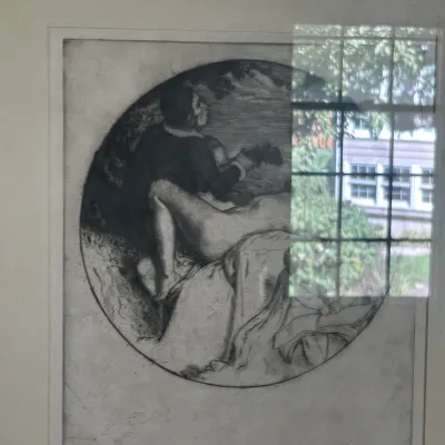 Sale Photo Thumbnail #119: Framed black and white etching featuring a circular composition of a seated figure playing an instrument beside a reclining nude, presented under glass with a white mat.