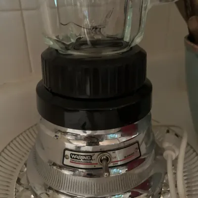 Vintage Waring Professional blender featuring a chrome base with a toggle switch and a clear glass pitcher.