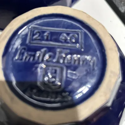 Emile Henry cobalt blue ceramic dish showing the maker's mark and model number 21-40 on the unglazed bottom rim.