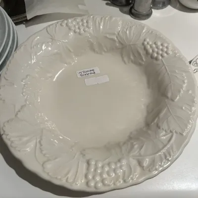 Williams Sonoma white ceramic serving bowl featuring an embossed grape and leaf border.