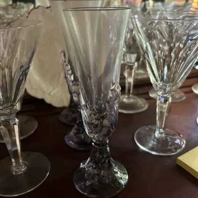 Collection of vintage crystal stemware, featuring a champagne flute with a textured, frosted base and stem alongside cut-glass wine goblets.