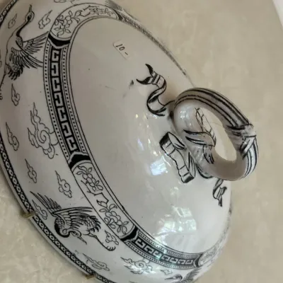 Vintage black and white transferware ceramic tureen lid featuring a crane and cloud motif with a ribbon-style handle.