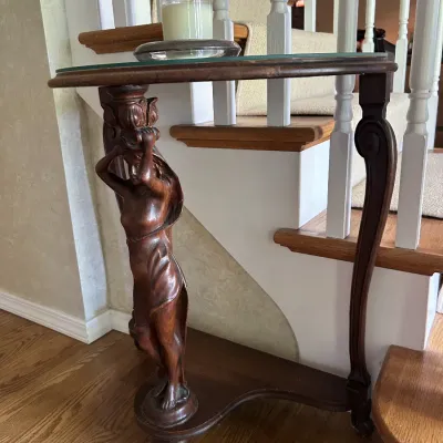Sale Photo Thumbnail #118: Vintage carved wood console table featuring a caryatid support figure and a glass top insert.