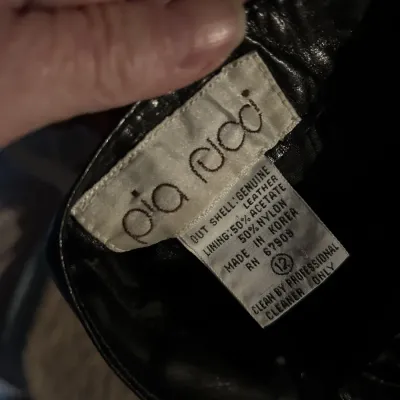 Vintage Pia Rucci black leather garment label, size 12, made in Korea.