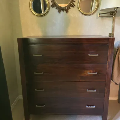 Sale Photo Thumbnail #109: Modern dark wood four-drawer chest with silver-tone bar pulls, shown with a trio of decorative gold-framed wall mirrors hanging above.