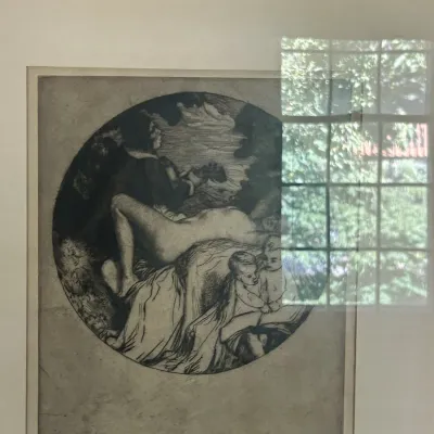 Sale Photo Thumbnail #120: Framed black and white etching featuring a circular composition of classical figures, including a reclining nude and children, presented under glass with a white mat.