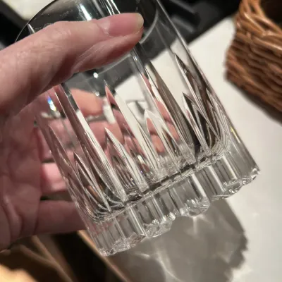 Heavy cut crystal double old fashioned glass with vertical wedge cuts and a thick, textured base.