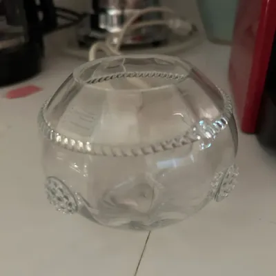 Vintage clear glass rose bowl featuring a beaded rim and textured circular medallions around the base.
