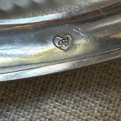 James Avery sterling silver jewelry piece, showing the signature heart and JA maker's mark stamped on the inner band.