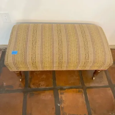 Classic Goldtone Upholstered Ottoman on Wheels