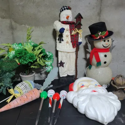 Sale Photo Thumbnail #143: Vintage plastic Santa Claus blow mold face, two snowman figurines, solar pathway lights, and artificial greenery.