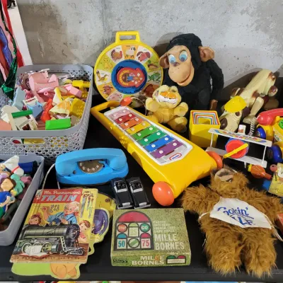 Sale Photo Thumbnail #125: Assortment of vintage children's toys and games, including a Fisher-Price See 'N Say, a Little Tikes xylophone, a Mille Bornes card game, and various plush animals and plastic figures.