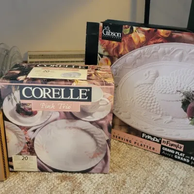 Sale Photo Thumbnail #35: Corelle Pink Trio 20-piece dinnerware set, a boxed ceramic turkey platter, and a box of clear glassware.