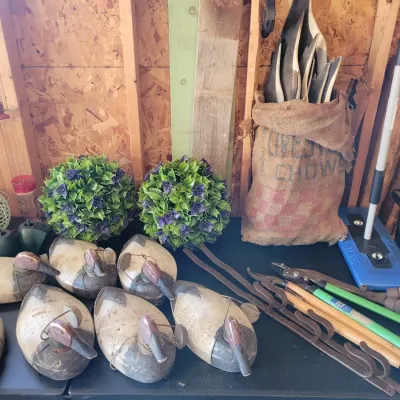 Sale Photo Thumbnail #197: Collection of vintage duck decoys, garden tools, and artificial topiary balls
