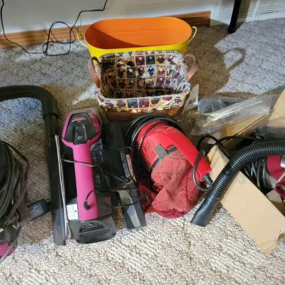 Sale Photo Thumbnail #45: Bissell hand vacuum, a Royal hand vacuum, a Shark vacuum.