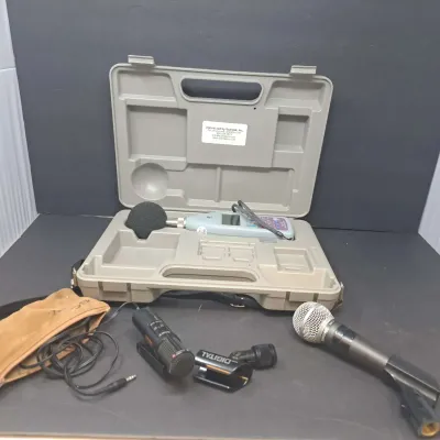 Scantek sound level meter in a hard plastic carrying case, accompanied by a Shure SM58 microphone and additional audio accessories.