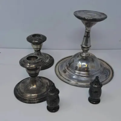 Assorted vintage weighted sterling silver tableware, including a pair of low candlesticks, a single tall candlestick, and a pair of small...