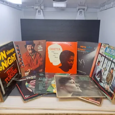 Collection of vintage folk and pop vinyl LP records from the 1960s, featuring artists such as Odetta, Tom Paxton, Pete Seeger, and The...