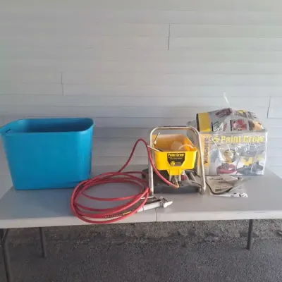 Wagner Paint Crew airless paint sprayer system, including the sprayer unit, hose, spray gun, manual, original box, and a blue plastic...