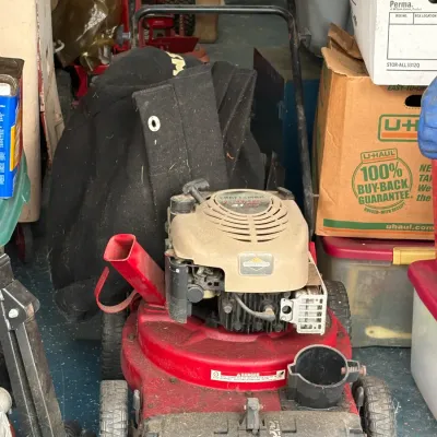 Craftsman 4-in-1 Plus 24-inch wide vacuum, shredder, chipper, and blower, showing signs of use and storage in a garage.