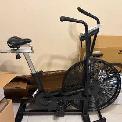 Assault Fitness AirBike Classic stationary exercise bike, featuring a black steel frame, adjustable seat, and large fan wheel, shown in...