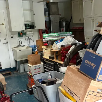 Assorted garage items, storage boxes, and utility cabinets, showing a variety of household goods and tools.