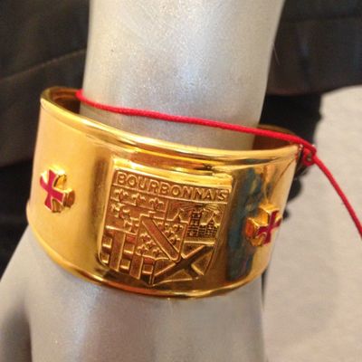 Vintage gold-tone PROVOST  heraldic crest cuff bracelet, featuring red enamel cross details on either side of the central shield. Needs...