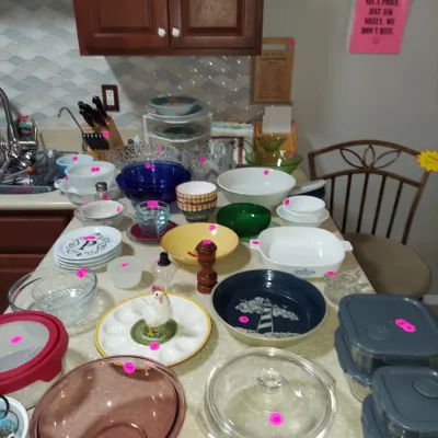 Sale Photo Thumbnail #9: Assorted kitchenware and glassware, including Pyrex mixing bowls, a ceramic deviled egg platter with a rooster centerpiece, and various baking dishes displayed on a kitchen counter.