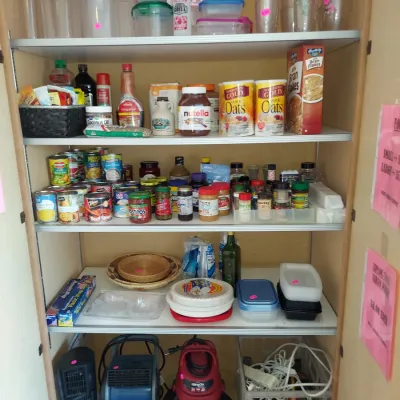 Sale Photo Thumbnail #23: Pantry cabinet filled with various kitchen goods, including food storage containers, canned goods, dry ingredients, and small household appliances on the bottom shelf.