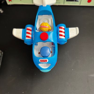 Sale Photo Thumbnail #46: Fisher-Price Little People blue toy airplane with pilot and passenger figures, showing light wear from play.