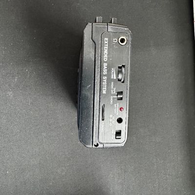 Sale Photo Thumbnail #59: Vintage portable cassette player with AM/FM radio, featuring an "Extended Bass System" and showing some surface wear from use.