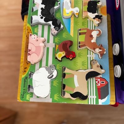 Melissa & Doug wooden farm animals chunky puzzle, showing some wear along the edges from gentle use.
