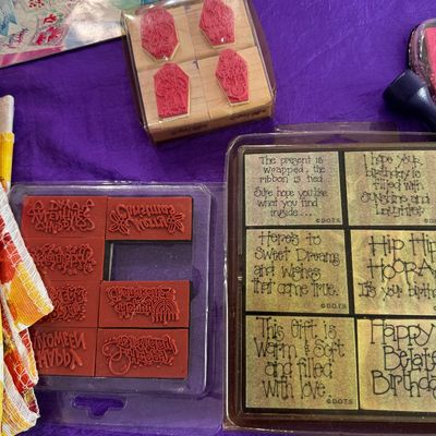Assorted rubber stamping supplies, including a set of D.O.T.S. sentiment stamps and holiday-themed red rubber stamps in their original...