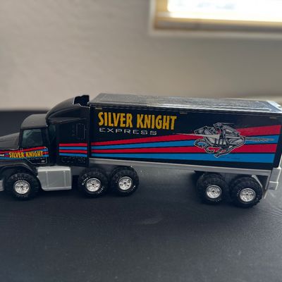 Sale Photo Thumbnail #27: Vintage Nylint Silver Knight Express semi-truck toy, featuring a black cab and trailer with red and blue stripes and knight graphic.