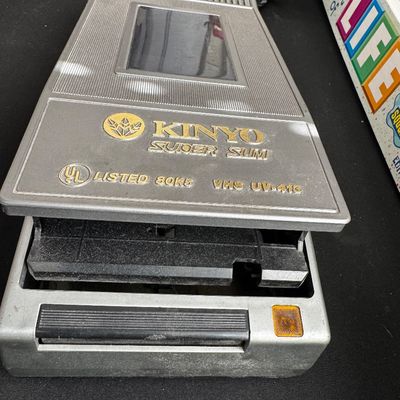 Sale Photo Thumbnail #62: Vintage Kinyo Super Slim VHS video cassette rewinder, model UV-410, showing some surface dust and wear.