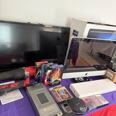 Collection of electronics and media, including an Apple iMac computer with original box, a flat-screen TV, Milwaukee power tools, a Kinyo...