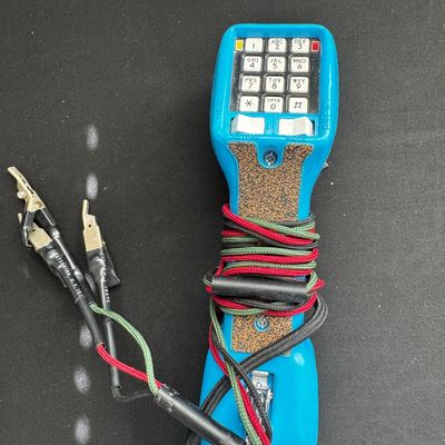 Sale Photo Thumbnail #42: Vintage Harris Dracon TS22 telephone test set in bright blue, featuring a push-button keypad and alligator clip leads.
