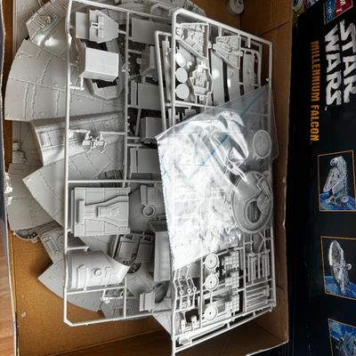 Sale Photo Thumbnail #52: Vintage AMT Ertl Star Wars Millennium Falcon plastic model kit, unbuilt in box with grey plastic sprues and parts.