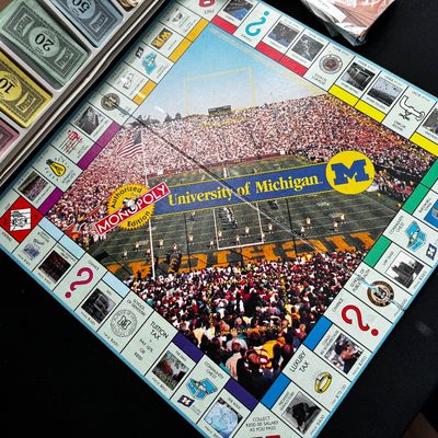 Sale Photo Thumbnail #30: Vintage University of Michigan edition Monopoly board game, complete with themed board and play money.