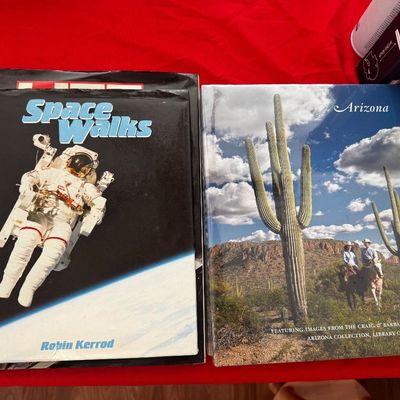 Two hardcover books, including "Space Walks" by Robin Kerrod and an illustrated book about Arizona featuring images from the...