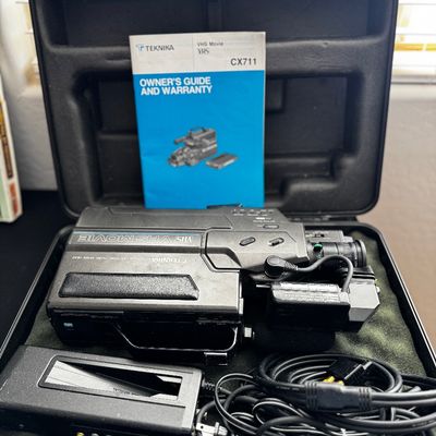 Sale Photo Thumbnail #39: Vintage Teknika CX711 VHS Movie camcorder with hard carrying case, owner's manual, charger, and power cables, circa 1980s.