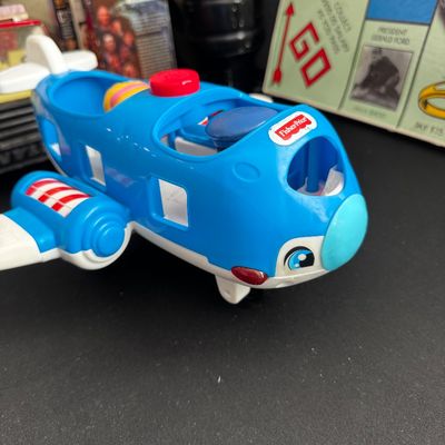 Sale Photo Thumbnail #44: Fisher-Price Little People blue toy airplane with white wings and a red button on top, showing light wear from play.