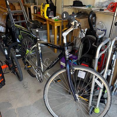 Trek Multitrack 7100 hybrid bicycle in silver and black, featuring a front suspension fork and a comfortable upright riding position.