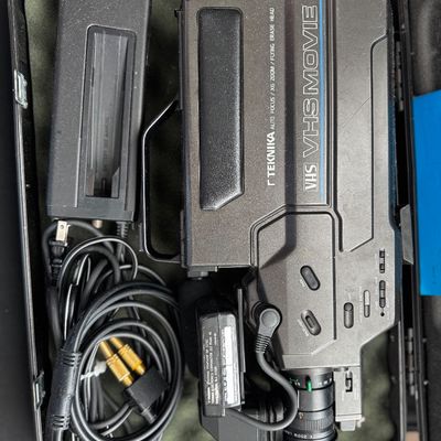 Sale Photo Thumbnail #40: Vintage Teknika VHS Movie camcorder with auto focus and x6 zoom, complete with power adapter, cables, and hard carrying case, circa 1980s.