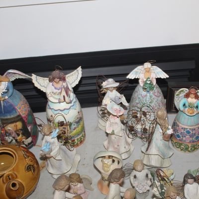 Collection of Jim Shore Heartwood Creek angel figurines and other decorative statues, including a small Santa figure and a vintage book...