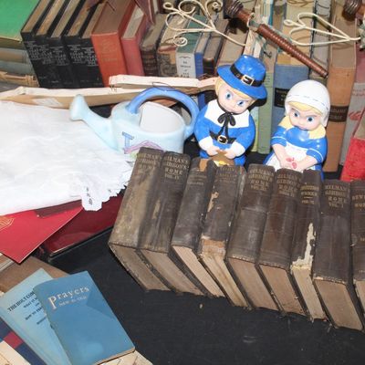 Assortment of vintage books, including a multi-volume set of Milman's Gibbon's Rome, displayed alongside a pair of ceramic...