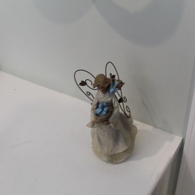 Sale Photo Thumbnail #6: Small angel figurine holding a nest of bluebirds, featuring wire wings with leaf accents.