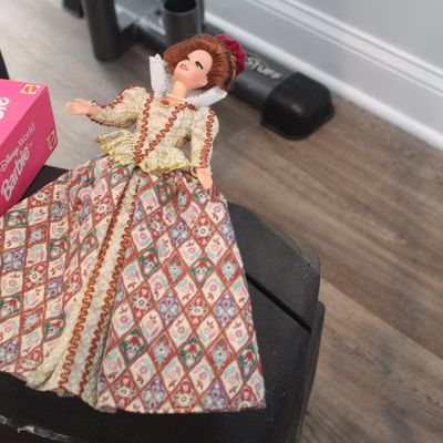 Sale Photo Thumbnail #42: Vintage Barbie doll dressed in an ornate Elizabethan-style gown with a high white collar and patterned skirt.