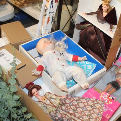 Collection of vintage and collectible dolls, including a porcelain baby doll in a baseball uniform, a Renaissance-style Barbie, and a...