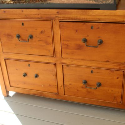 Sale Photo Thumbnail #18: Rustic pine four-drawer chest with metal bail pulls and keyholes, showing a warm honey finish.